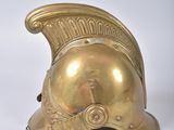 a close up of a gold helmet on a white surface