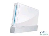 a white video game console sitting on top of a white table
