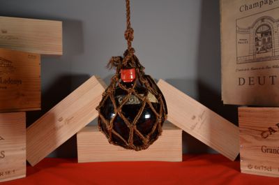 a bottle of wine that is hanging from a rope