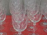 several empty wine glasses are lined up on a red table