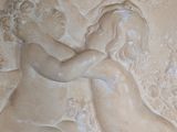 a relief of a woman and a dog on a wall