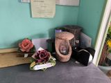 a vase of flowers on a table next to a vase of flowers