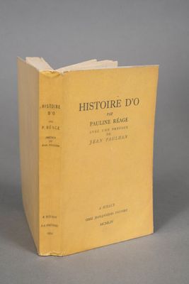 an old book with a yellow cover sitting on top of a table