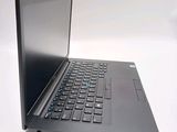 a laptop that is open on a white surface