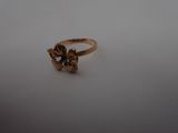 a close up of a gold ring on a white surface