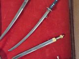 a lot of different types of swords displayed in a display case