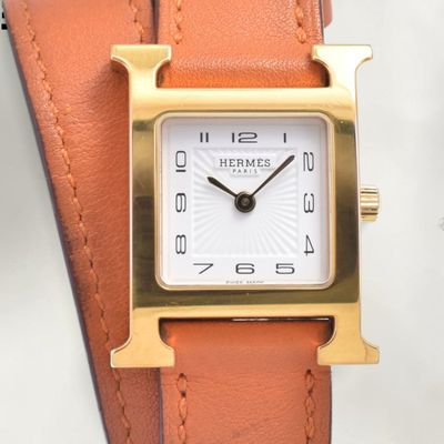 an image of a close up of a wrist watch on a white surface