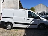 a white van parked in a parking lot next to a building
