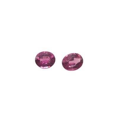 a pair of pink tourmaline gems on a white background