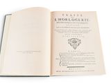 an open book on a white surface with a black border