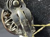 a close up of a metal object on a string