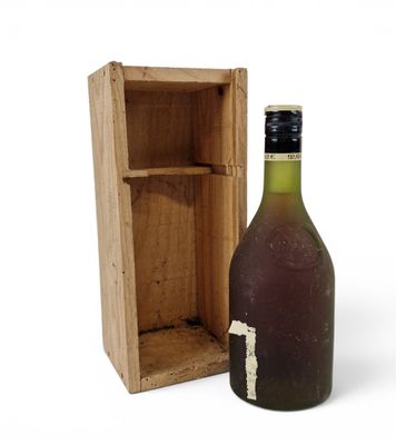 a bottle of wine sitting next to a wooden box