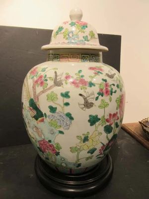 a vase that is sitting on a table with a lid