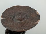 a statue of a man holding a wooden shield