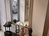two vases and a mirror on the floor in a room