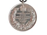 silver medal on a chain with a crown on top of it