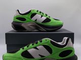 a pair of green and black sneakers sitting on top of a box
