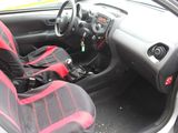 the interior of a car with red and black seats and a steering wheel