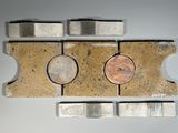 a penny sitting on top of a piece of metal