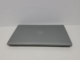 the dell laptop is sitting on a table with a white background