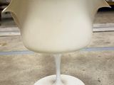 a white chair that is sitting in the middle of a room