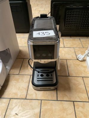une cafetière posée sur le carrelage d'une cuisine
