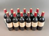 six bottles of wine are lined up in a row on a table