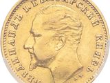 un gros plan d'une pièce d'or représentant le profil d'un homme