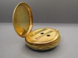 a small gold pocket with a button on it