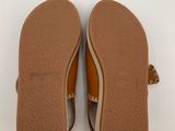 a pair of brown sandals with tassels on them