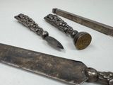 a knife, knife sharper, and other items that are on a table