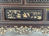 a black and gold cabinet with flowers and birds on it