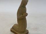figurine of a woman holding a rosary on a white background