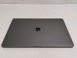 a black apple laptop sitting on a white surface