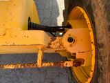 a close up of a yellow wheel on a tractor