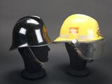 pair of yellow and black hard hats sitting on top of a black mannequin head