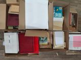 a box full of books sitting on a wooden floor