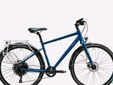 a blue bicycle that is parked on a white surface