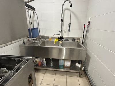 a kitchen with a sink and a stove in it