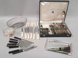 a box of silverware and a tray of knives and spoons