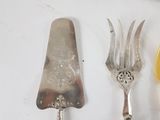 three forks and a knife sitting on a table