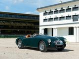a green sports car parked in front of a white building