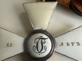 a white cross with a black and gold ribbon on it