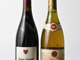 deux bouteilles de vin posées l'une à côté de l'autre sur une table en bois