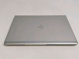 a laptop that is sitting on a white surface