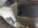 a silver spoon with a brush in it on a table