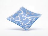 a blue and white plate with a design on it