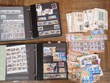 a lot of stamps on a table with a binder