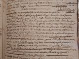 an old book with writing on it sitting on a table