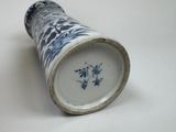 a blue and white vase sitting on a white surface